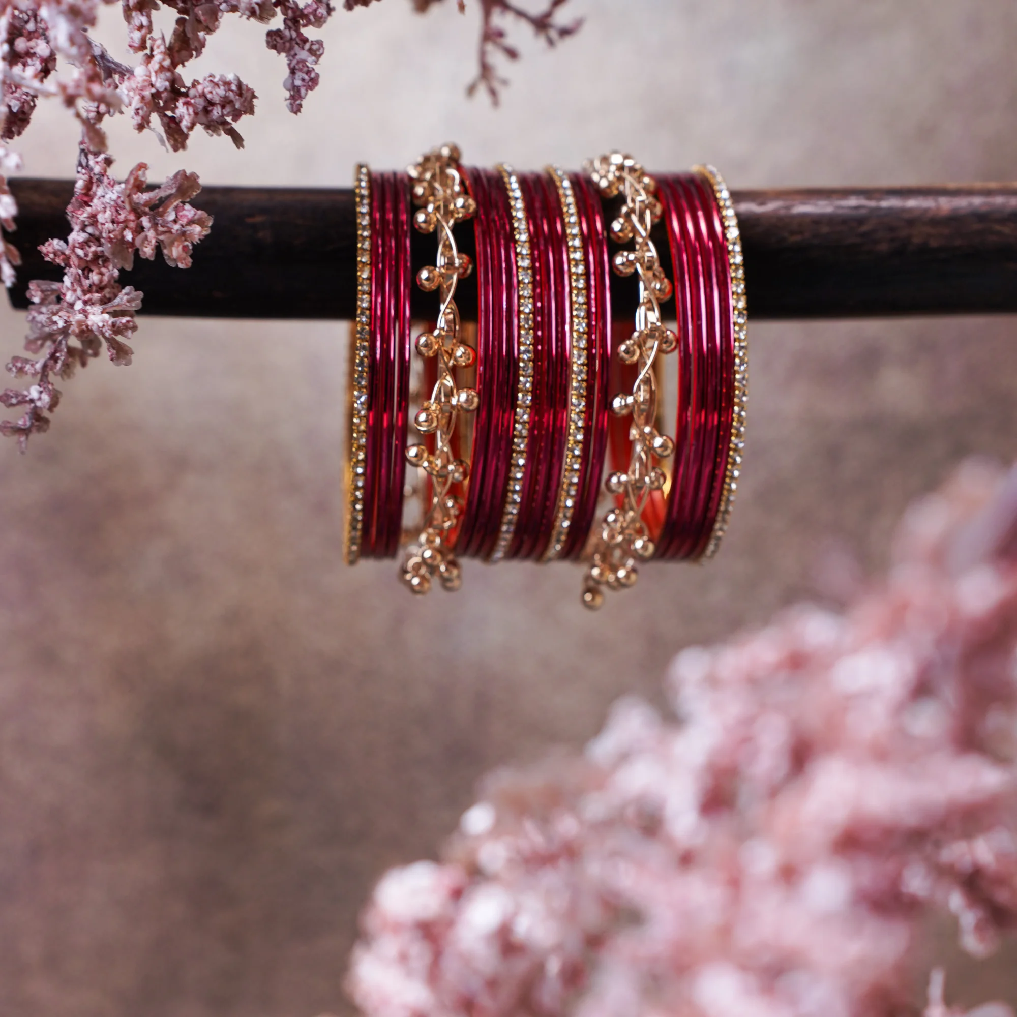 A vibrant, trendy metallic red and gold bangle stack with delicate stylish ghungroo charms and subtle sparkle. Ideal for daily wear, college girls, festive gatherings to wedding celebrations.